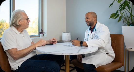 a doctor talking to a long term care resident with an air purifier in the background