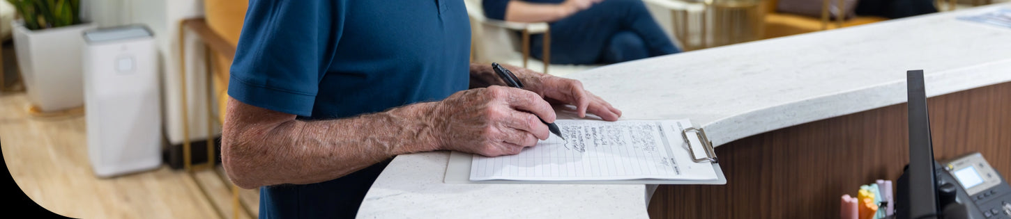 an air purifier in a doctors office lobby while a patient fills out forms