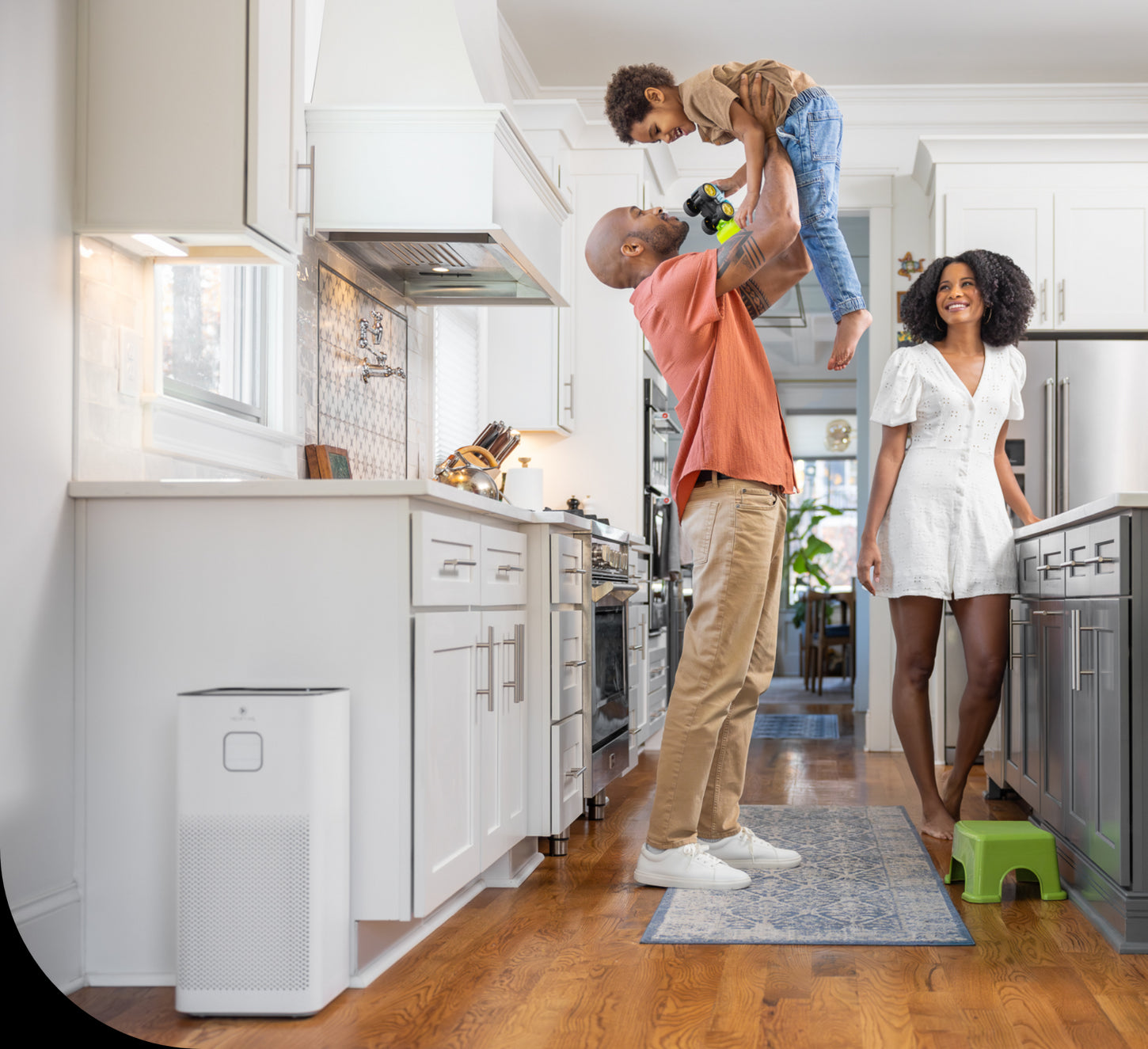 a family in a kitchen with an air purifier