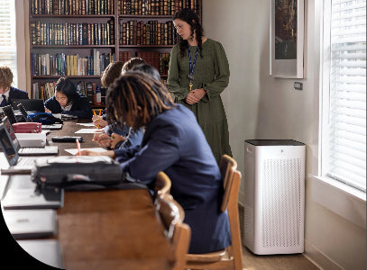 a group of students learning in a library with an air purifier