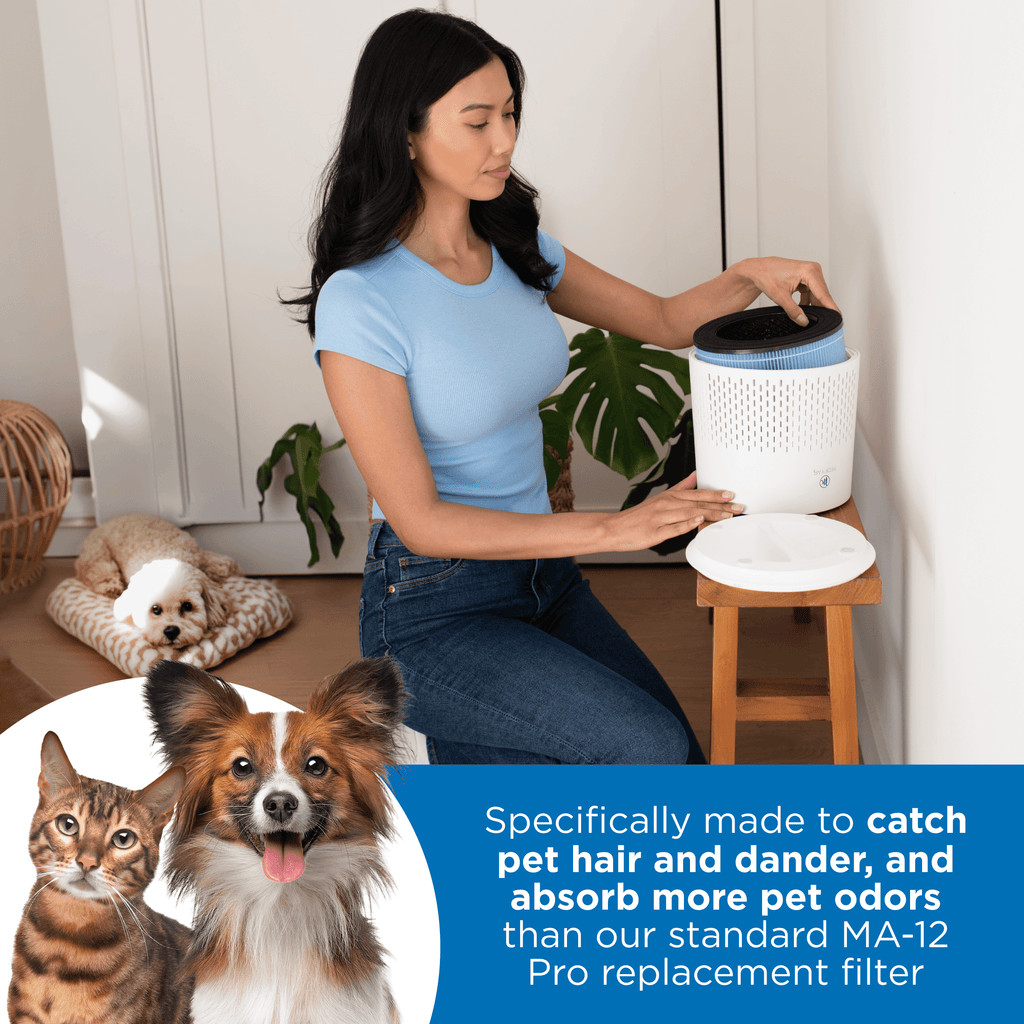 women in a room at home with her pet dog laying on dog bed while she is changing out her MA 12 air purifier filter. Text at the bottom reading specifically made to catch pet hair and dander, 