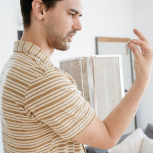 Man holding old filter for MA-50 Air Purifier