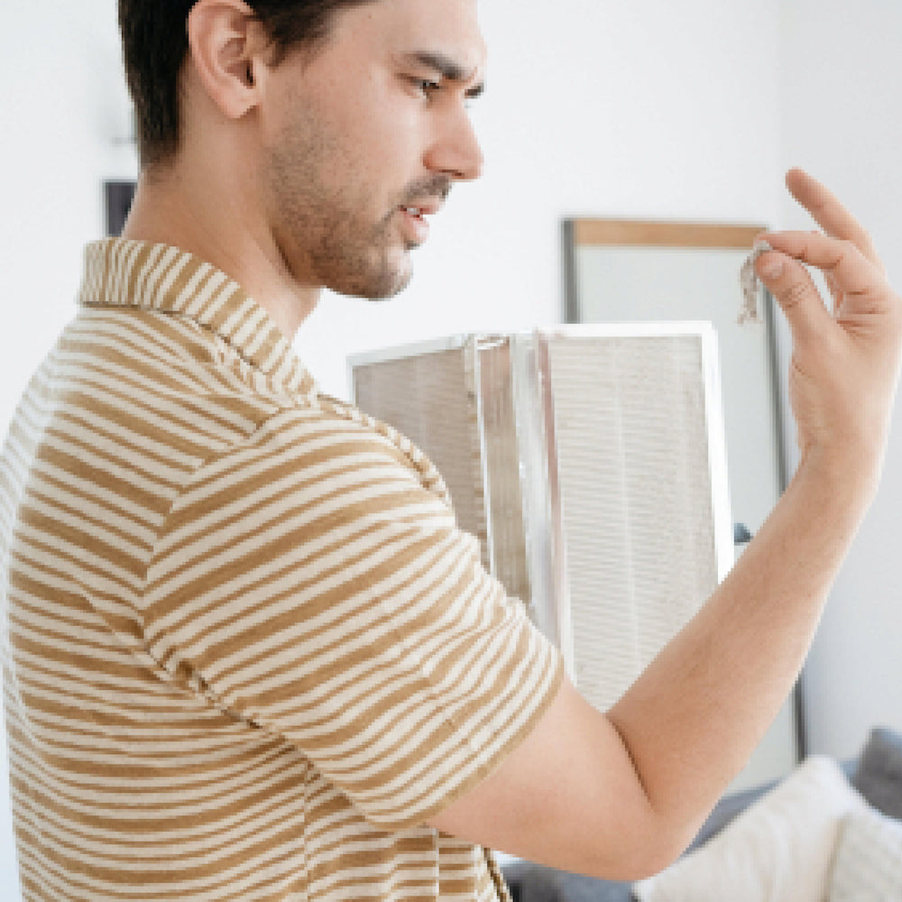 Man holding old filter for MA-50 Air Purifier